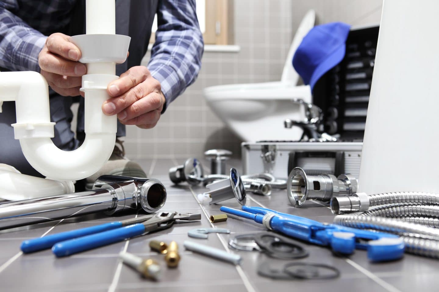 plumber-at-work-in-a-bathroom-1440x960